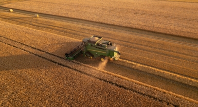 Aerial,View,Of,Combine,Harvester,At,Work.,Summer,Field,Work